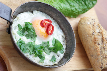 Fried egg with coriander chili and whole grain bun.