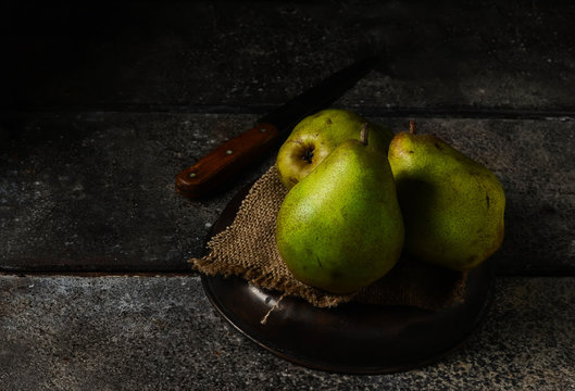 Fresh pears on dark rustic background