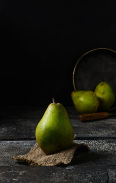 Fresh pears on dark rustic background