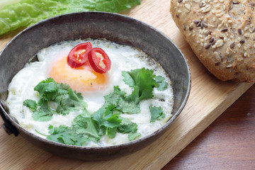 Fried egg with coriander chili and whole grain bun.
