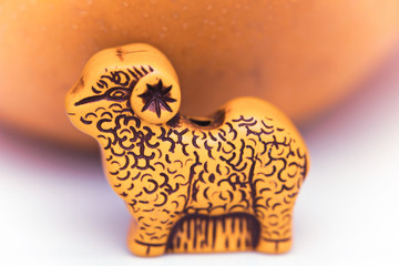 small figure of a lamb with orange in the background