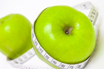 Green apple with measuring tape