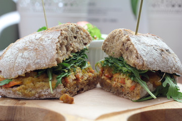 Bombay masala sandwich with chicken, rocket and green salad.