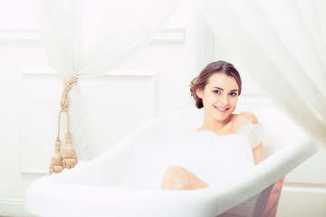 Beautiful young woman taking a bath