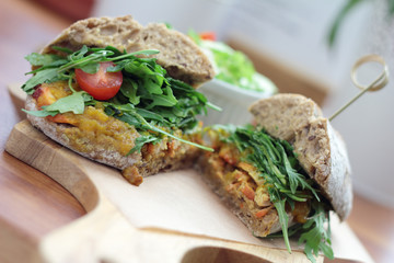 Bombay masala sandwich with chicken, rocket and green salad.