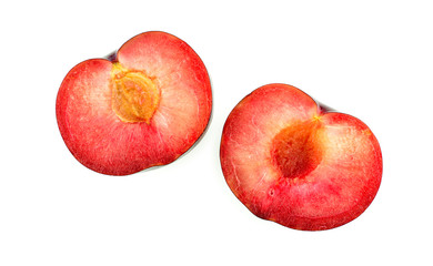 Plum cut in half, vibrant juicy insides
