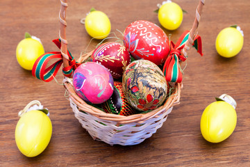 Easter eggs in a basket on an old wooden table.