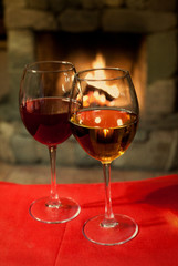 Two glasses of wine. Fireplace. vintage paper background