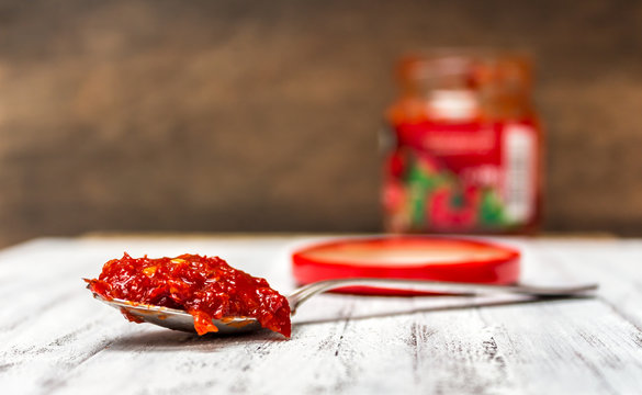 A jar and a spoonful of Hungarian hot paprika paste