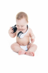 A young baby is sitting on a white isolated background listening