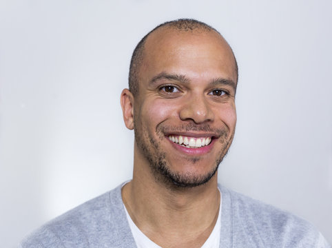 Portrait of a man in a tee shirt smiling to camera