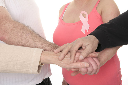 A woman holding a breast cancer logo