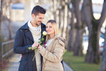 Portrait of a romantic young couple walking on the street