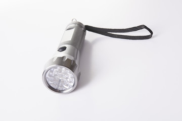 A gray flashlight over a gray background on the floor