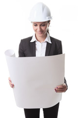 Attractive architect holding blueprints and wearing helmet. All
