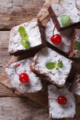 brownie cake with mint and cherry on paper vertical top view