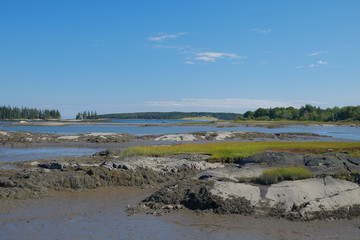 A secluded small bay and estuary at low tide showing the large g
