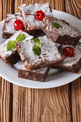 cake brownies with walnuts on a plate. Vertical closeup