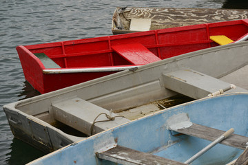 Wooden and metal rowboats and skiffs docked