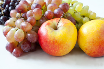 Naklejka na ściany i meble Apples and grapes on a white background.