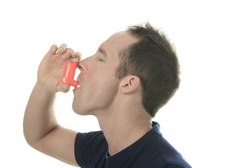 Young man using  an asthma inhaler as prevention