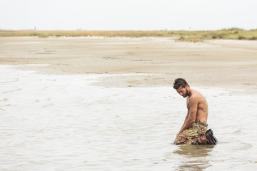 Muscled Shirtless Soldier in Camouflage Pants and Black Shoes Kn
