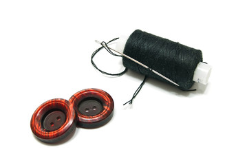 spool of thread and two buttons