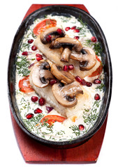 Fish baked with vegetables and mushrooms