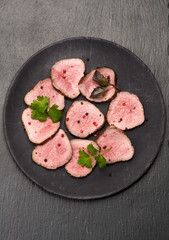 roast beef slices on the chalkboard. top view