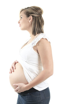 Young pregnant woman against white background
