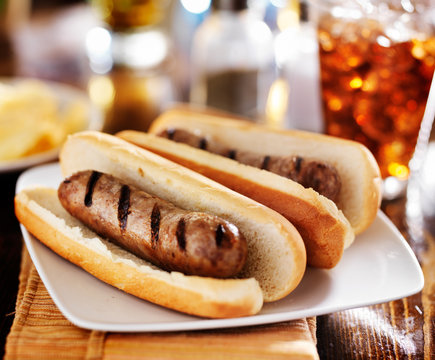 bratwursts that were grilled with cola and potato chips