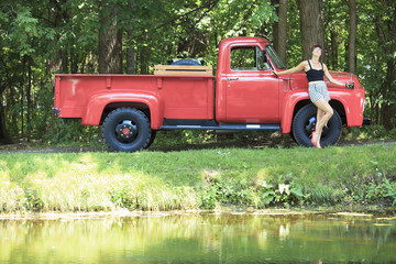 A retro girl with a beautiful red old car.