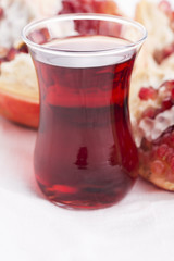 Ripe pomegranates with juice on table