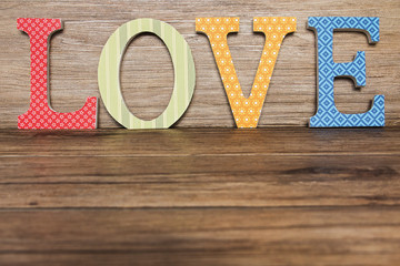 Handmade letters Love over wood background with copy space