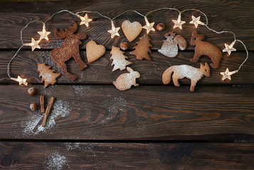 Homemade fancy cookies with garland on the wood background