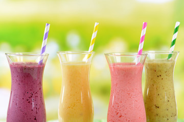 Delicious berry cocktails on table on bright background