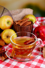 Composition of  apple cider with cinnamon sticks, fresh apples