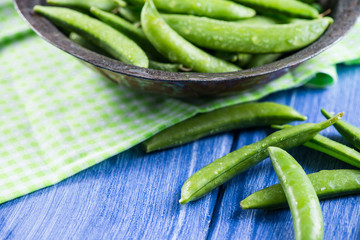 Whole fresh peas in vintage bowl