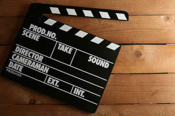 Movie clapper on wooden background