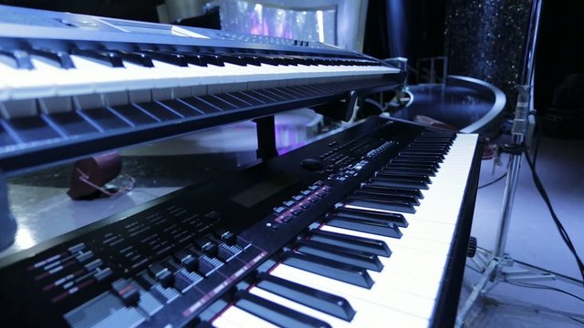 Pan of two Keyboards on a Stage.  Great lighting