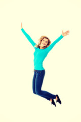 Young casual woman, student jumping.