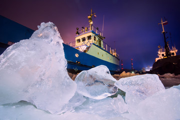 The Icebreaker ship trapped in ice tries to break and leave the  © tsuguliev