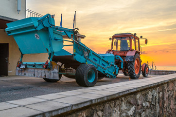 Tractor with beach cleaning tool near the Baltic sea