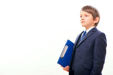 Business child in suit and tie posing with a clipboard