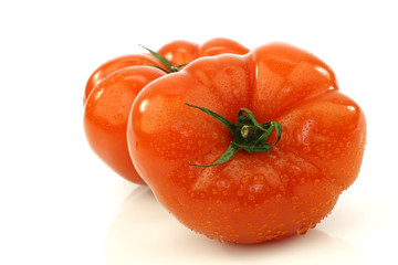 two beef tomatoes on a white background