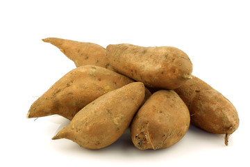 bunch of sweet potatoes on a white background