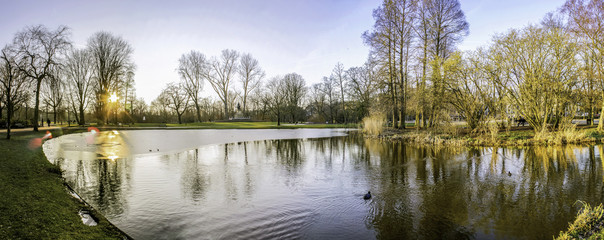 Fototapeta premium Pond panoramic landscape photo in Vondelpark, Amsterdam. Is a pu