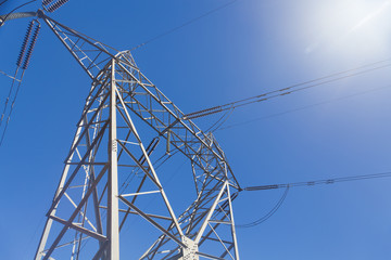 Electricity pylon against blue sky