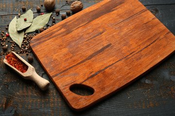 Different spices and herbs with cutting board