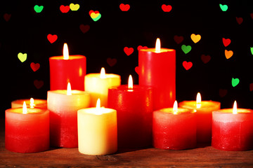 Fototapeta na wymiar Romantic gift with candles on lights background, love concept
